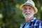 Senior man in hat standing in garden