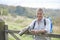 Senior Man Having Drink From Flask Whilst On Walk