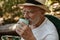 Senior man having refreshing coffee at campsite