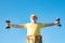 Senior man in health club. Senior fitness man training with dumbbells isolated on blue background. Senior sportman