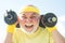 Senior man in his seventies training and lifting weigh. Health club or rehabilitation center for elderly aged pensioner