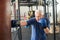 Senior man hitting punching bag in boxing studio.