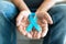 Senior man holding a blue cancer awareness ribbon