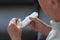 Senior man holding container with pills, closeup