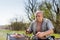 Senior Man Holding Knife While Grilling Outside