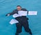 Senior man holding mortgage loan document in water