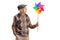 Senior man holding a spinning pinwheel and looking at it