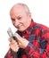 Senior man holding a stack of money. Portrait of an excited old businessman