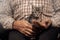 Senior man holds in hand small kitten. Concept support friendship animals cat and people love