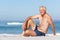 Senior Man On Holiday Sitting On Sandy Beach