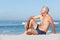 Senior Man On Holiday Sitting On Sandy Beach