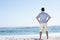 Senior Man On Holiday Standing On Sandy Beach