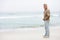 Senior Man On Holiday Standing On Winter Beach