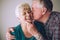 Senior man kissing wife on cheek