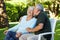 Senior man kissing woman in garden