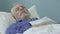 Senior man lying in bed and sleeping, healthy sound sleep, time in retirement