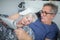 Senior man lying in bed with wife reading newspaper