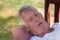 Senior man lying on bench in garden