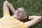 Senior man lying on grass contented