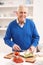 Senior Man Making Sandwich In Kitchen