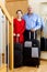 Senior man and mature girl with suitcases