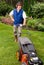 Senior man mowing lawn.