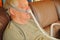 Senior man naps with CPAP device