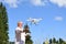 Senior man navigates unmanned aerial vehicle among nature