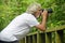 Senior man photographer & traveller taking nature & wildlife photos