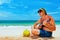 Senior man play reggae on Hawaiian guitar on caribbean beach