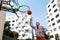 Senior man playing basketball outdoors on basketball court in city. Older, vital man has active lifestyle, doing sport