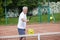 Senior man playing tennis