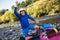 Senior man preparing for kayak tour on a mountain river