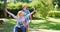 Senior man pushing wife sitting on wheelbarrow