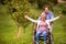 Senior man pushing woman in wheelchair, green autumn nature