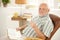 Senior man reading in armchair