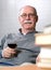 Senior man reading books with a glass of wine