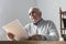 Senior man reading a paper document or letter