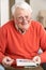 Senior Man Relaxing In Chair At Home