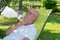 Senior man relaxing in the deckchair in his garden