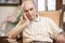 Senior man resting in armchair