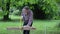 Senior man sawing a log handsaw closeup