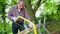 Senior man sawing a log handsaw closeup