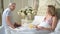 Senior man serving breakfast to woman in bed