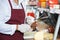 Senior Man Sharpening Knives In Cheese Shop