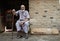 Senior man sitting on a chair on front of his little shop. Gizeh Egypt. Urban scene, proud muslim man.