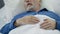 Senior man sleeping in bed and snoring, problems with sleep, health care