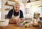 Senior, man and smile for cooking in portrait in kitchen while happy, proud or home. Elderly, chef or food in retirement