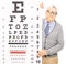 Senior man standing behind eyesight test