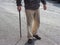 senior man street walking with wood cane
